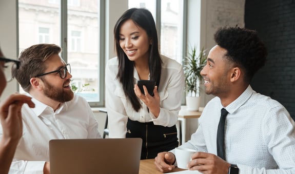 cherful-positive-young-colleagues-using-laptop-computer